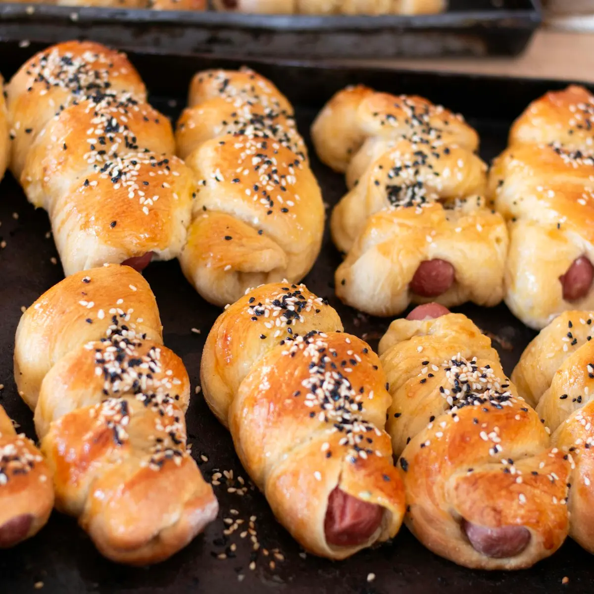 Seeded sausage twists on a tray