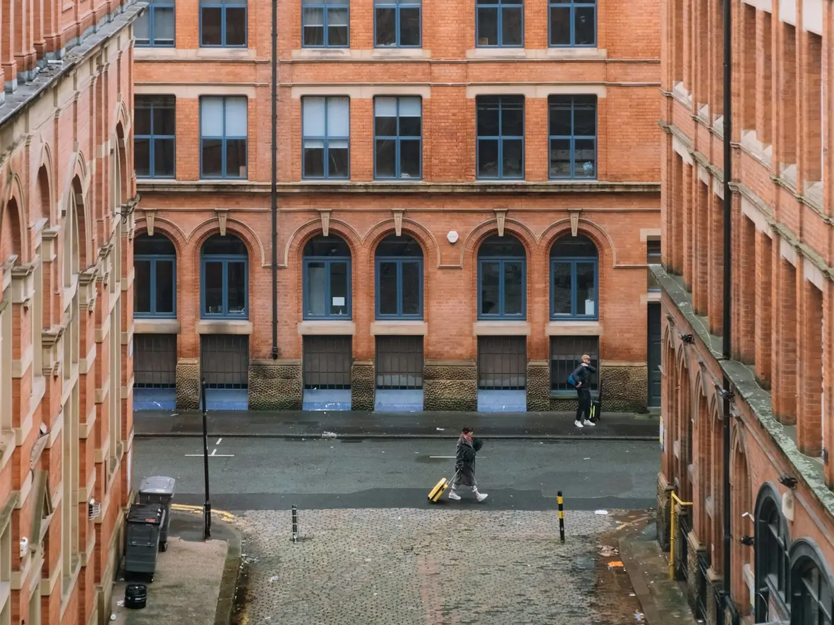 The courtyard of a red-brick mill building in Manchester