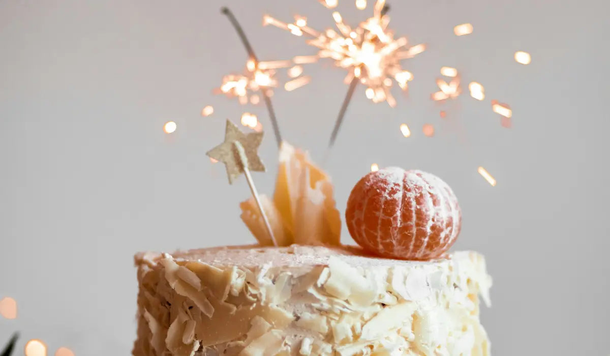 A celebration cake with a lit sparkler