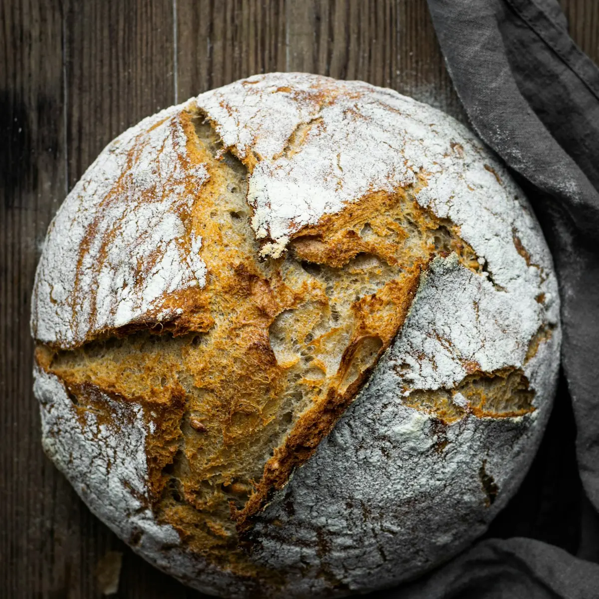A dark, flour-dusted sourdough loaf