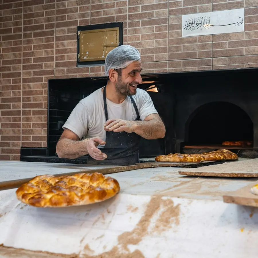 Tom laughing by the wood-fired oven