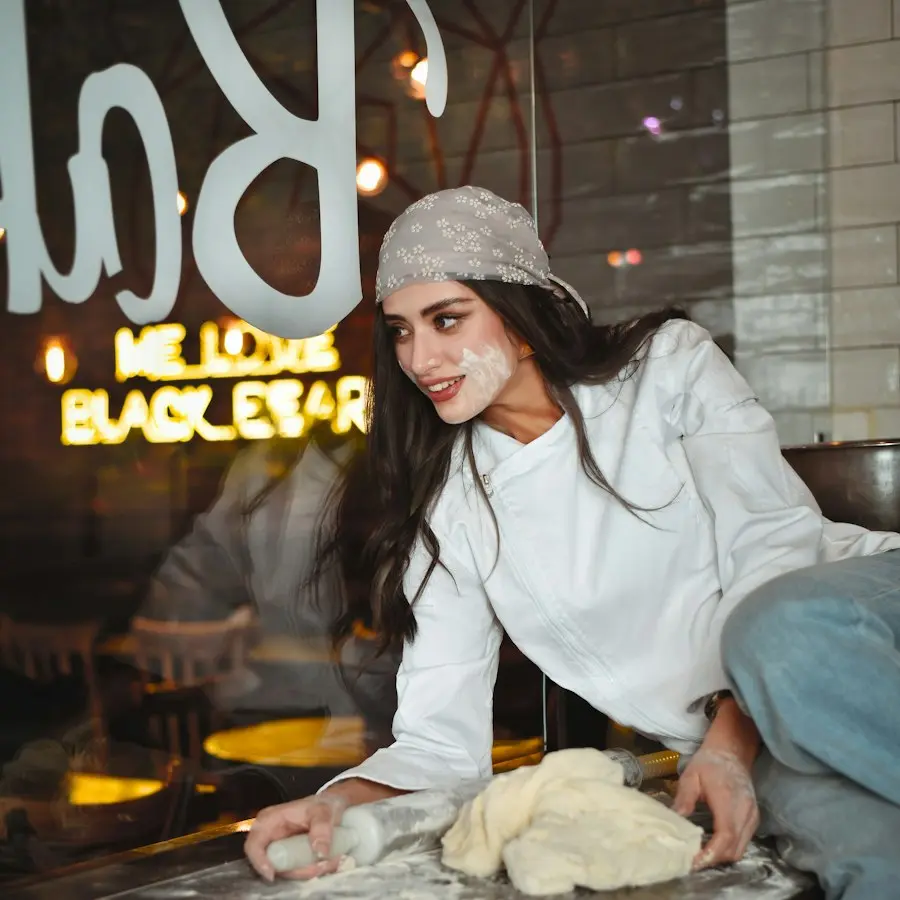 Aisha shaping dough in the bakery
