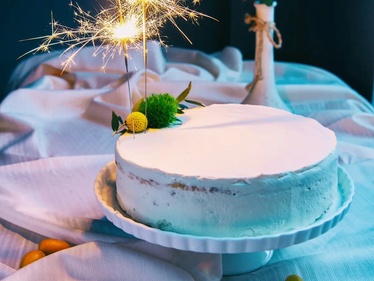 A white cake with sparkler candles
